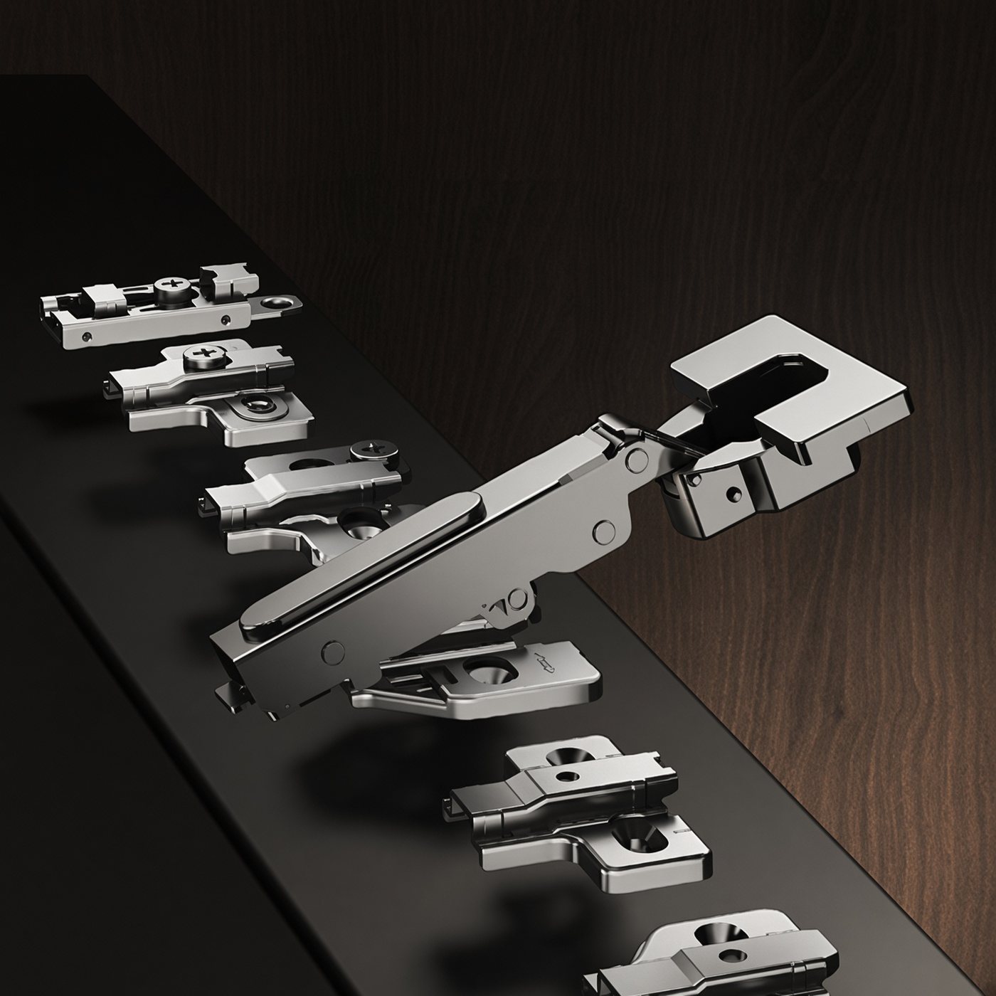 A concealed hinge arm shown above its mounting plate, with alternative plates alongside
